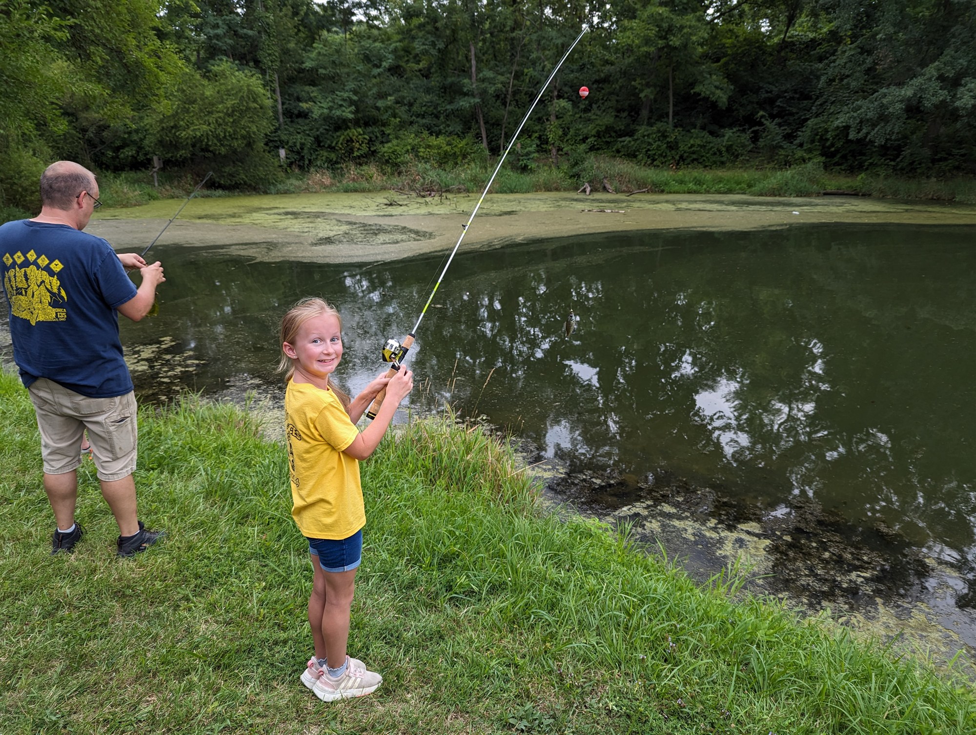 Lucy fishing during an Arrow of Light campout
