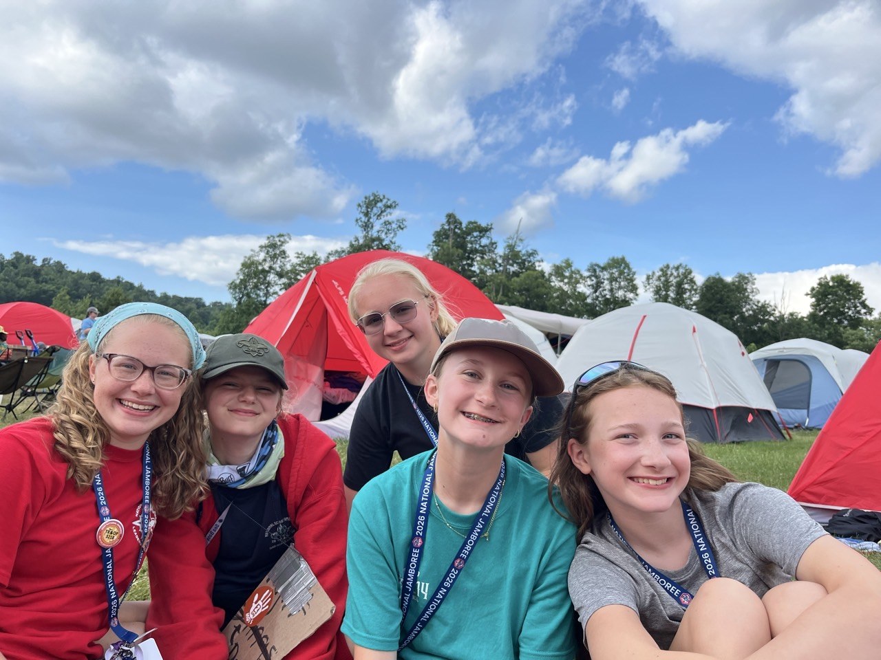 Lucy smiling with friends in their Jamboree campsite