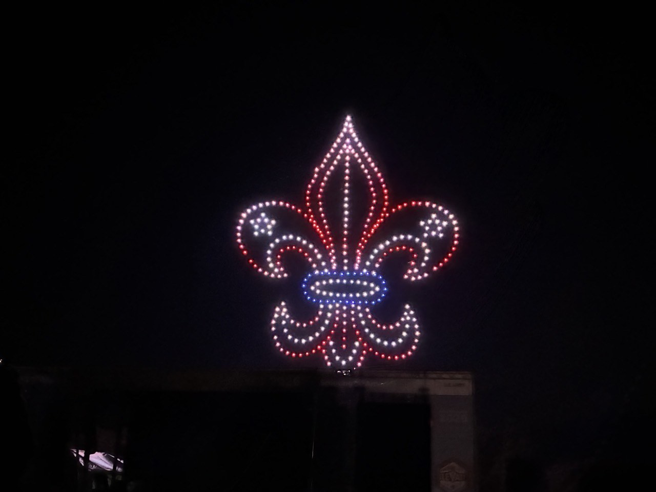 A Scouting fleur-de-lis formed by drones at the arena show