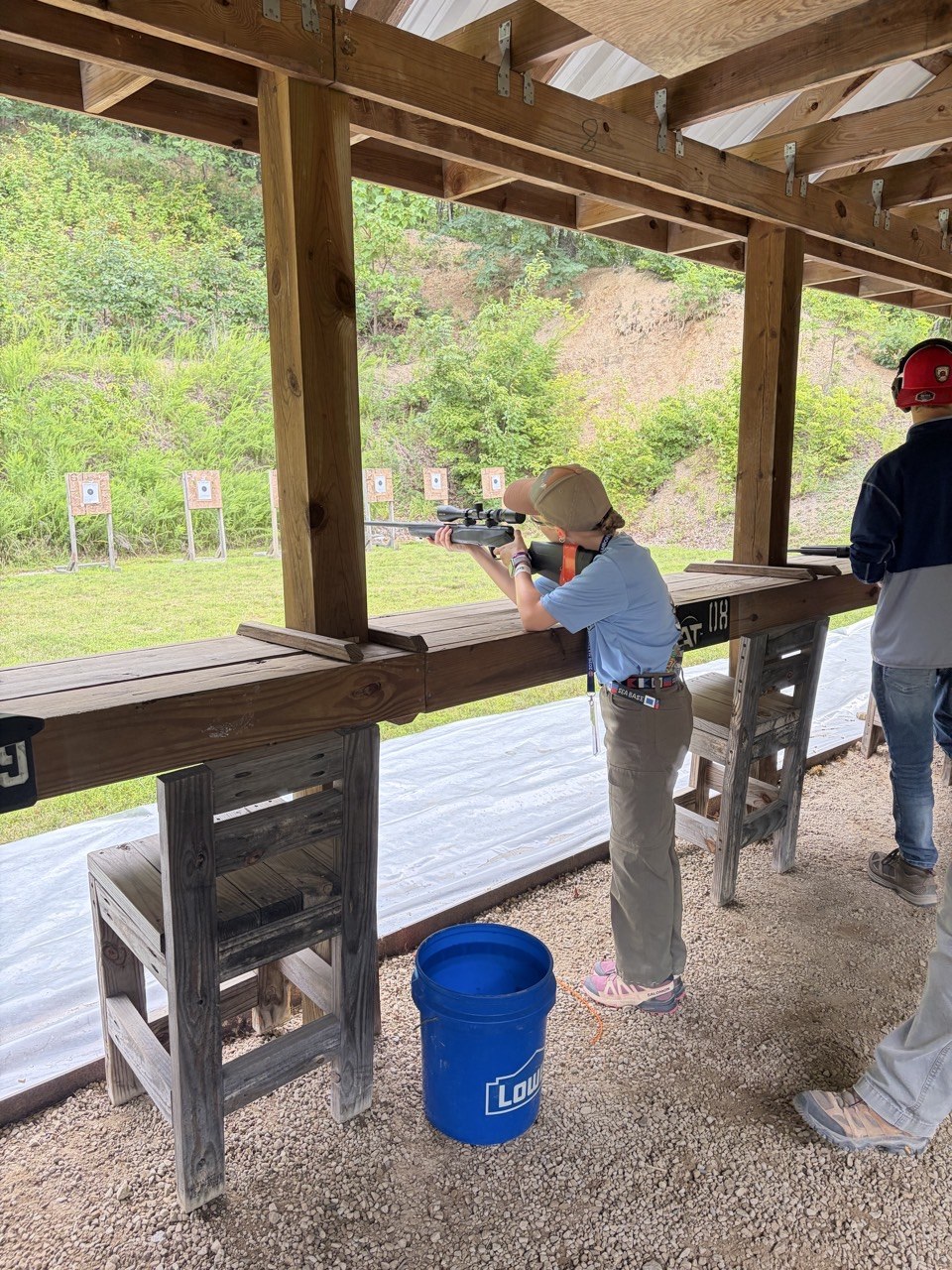 Lucy participating in shooting sports at the Jamboree