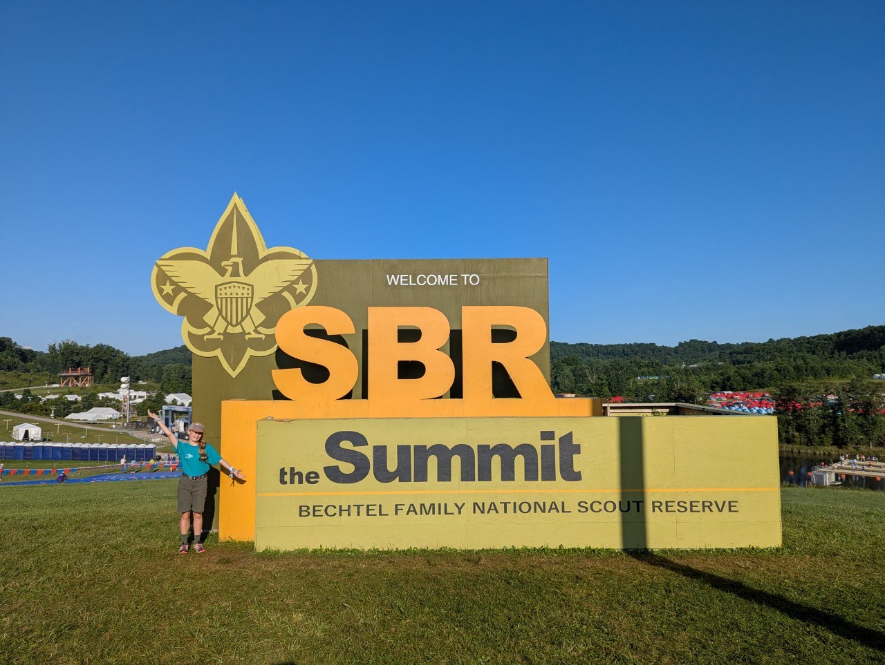 Lucy at the Summit Bechtel Reserve entrance sign